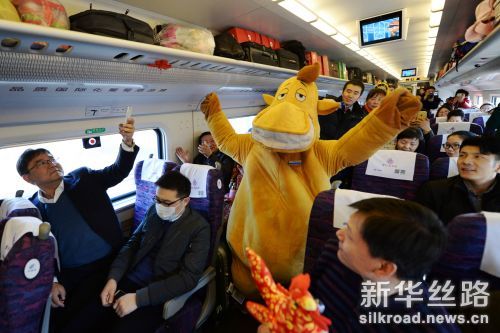 1月24日，兰州铁路局官方吉祥物“驼小明”在兰州开往嘉峪关的D2745次动车车厢内和旅客互动。