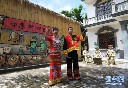 中廖村村民刘志坚(右)和朱爱琼夫妇在院子里唱黎歌(7月13日摄)。新华社记者 杨冠宇 摄