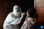 Chinese experts conduct COVID-19 tests in Laos for returning Chinese nationals